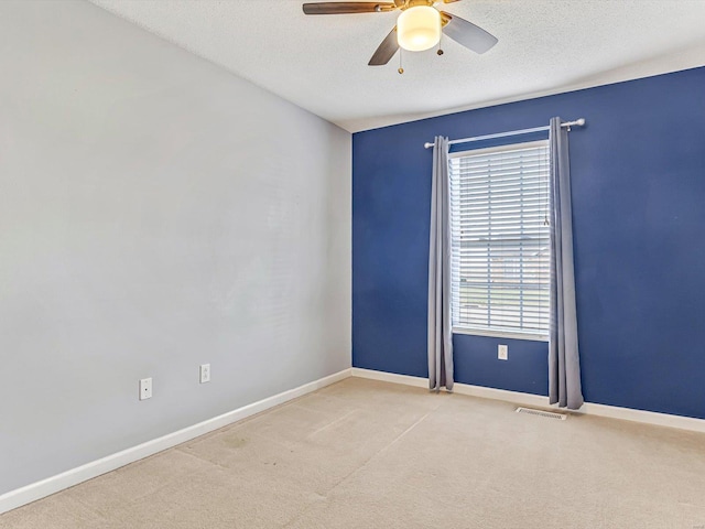 unfurnished room featuring visible vents, a textured ceiling, and baseboards