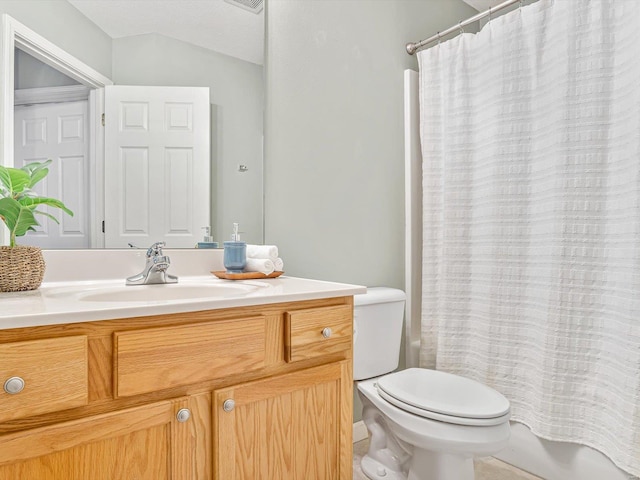 bathroom with toilet, shower / bath combo, and vanity