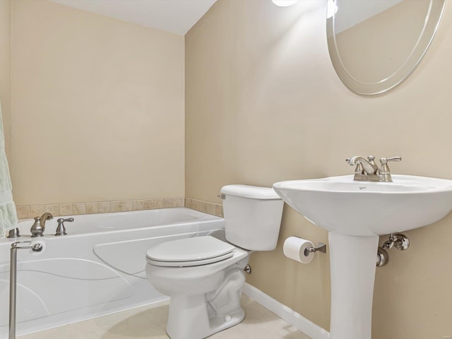 full bathroom with a bath, tile patterned flooring, toilet, and baseboards