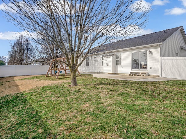 view of yard with a fenced backyard, a playground, and a patio