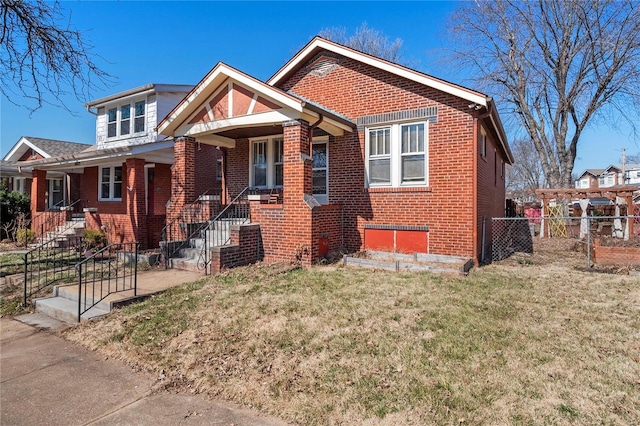 bungalow-style house featuring brick siding, a front yard, and fence