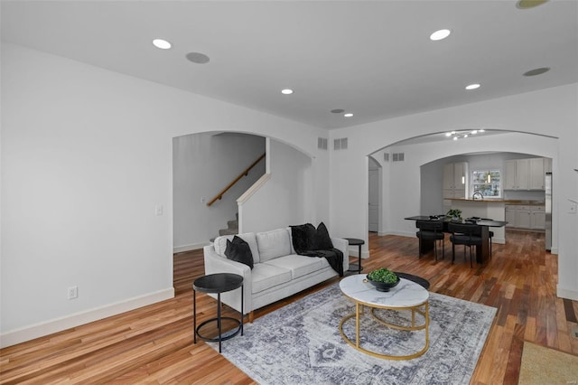 living area featuring recessed lighting and wood-type flooring