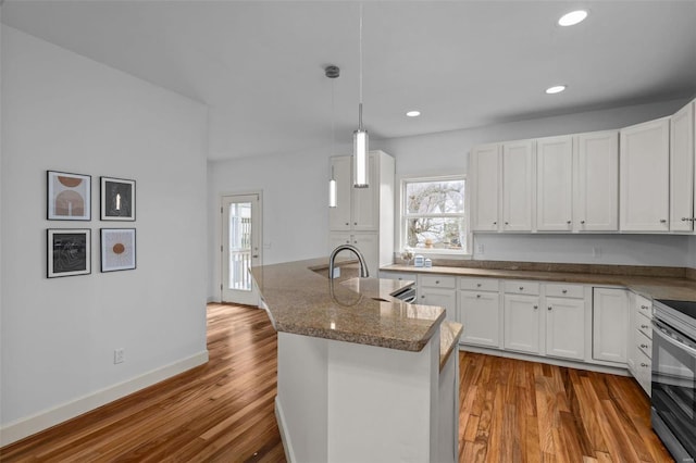 kitchen featuring recessed lighting, white cabinets, and wood finished floors