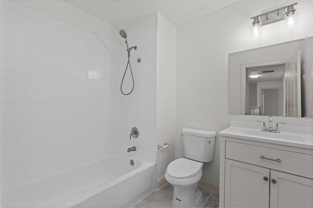 bathroom with vanity, toilet, baseboards, and shower / bathtub combination