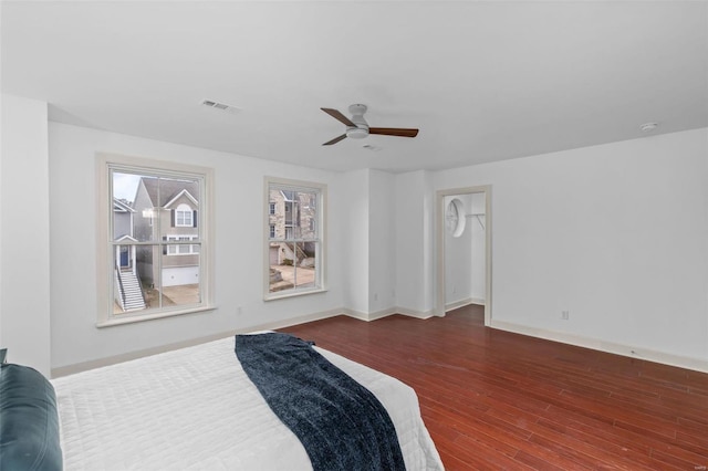 bedroom with visible vents, ceiling fan, baseboards, and wood finished floors