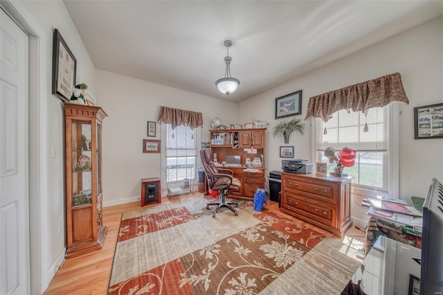 office with baseboards and light wood finished floors