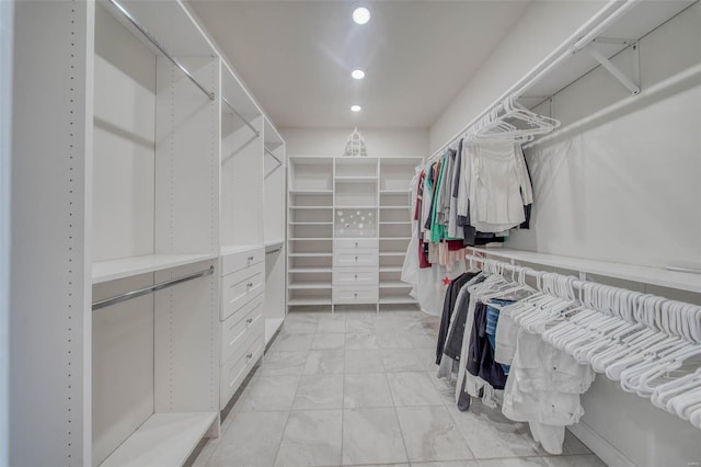 spacious closet featuring marble finish floor