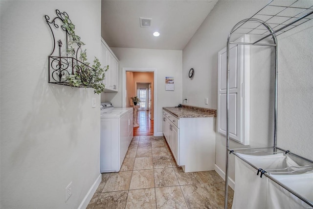 laundry area featuring visible vents, cabinet space, independent washer and dryer, and baseboards