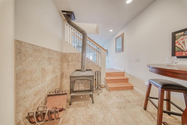 staircase featuring a wood stove and recessed lighting