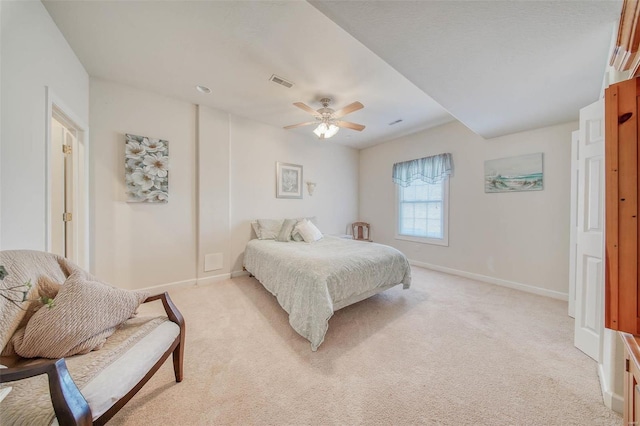 bedroom featuring light carpet, visible vents, and baseboards