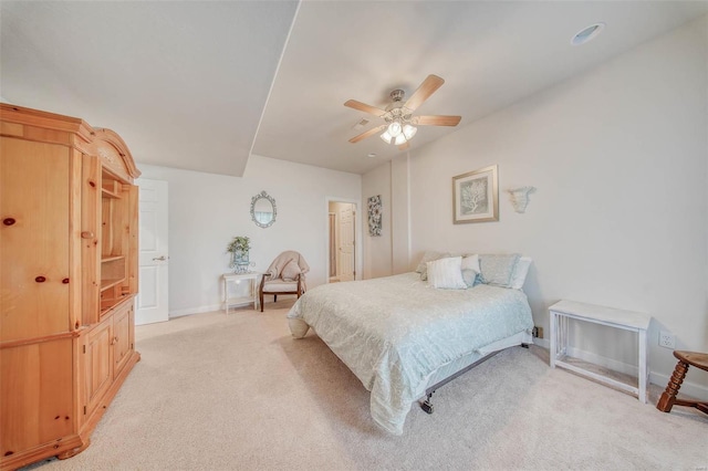 bedroom with a ceiling fan, baseboards, and light carpet