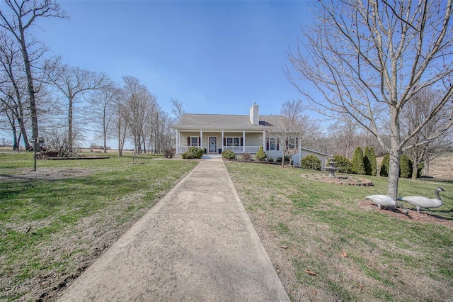 view of front of property featuring covered porch, driveway, a chimney, and a front yard