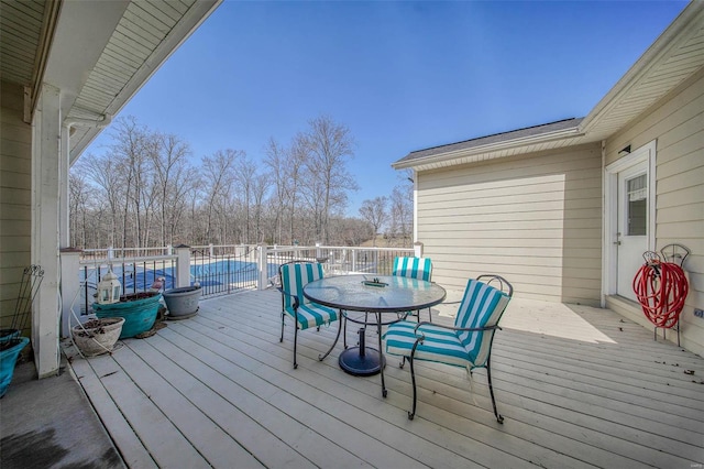 wooden deck featuring outdoor dining area