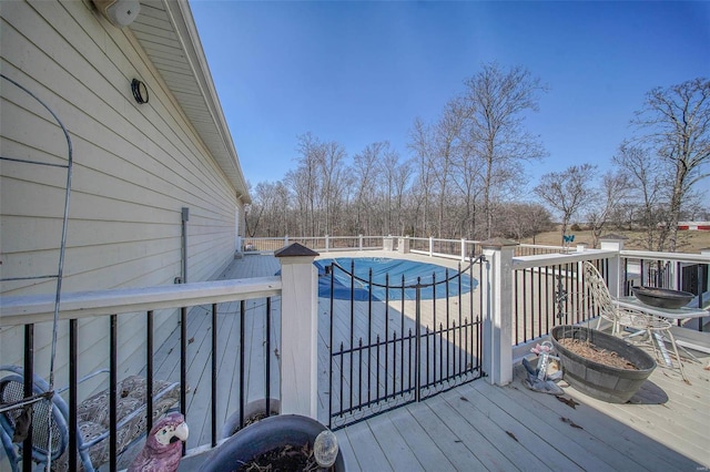 wooden deck featuring a fenced in pool