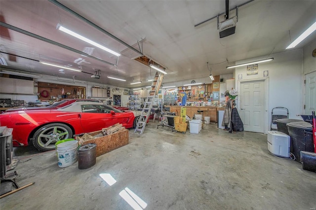 garage with a workshop area and a garage door opener