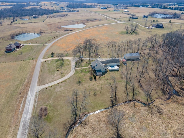 aerial view with a rural view and a water view