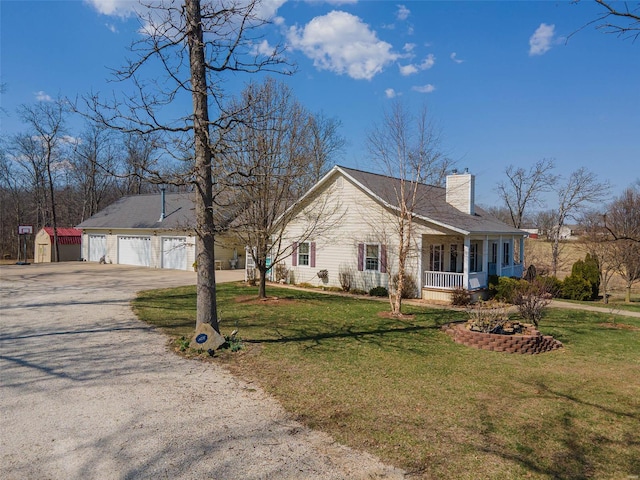 view of front of property featuring a garage, a porch, driveway, and a front lawn