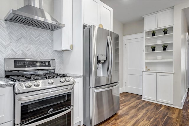 kitchen with wall chimney range hood, light stone counters, appliances with stainless steel finishes, white cabinetry, and open shelves