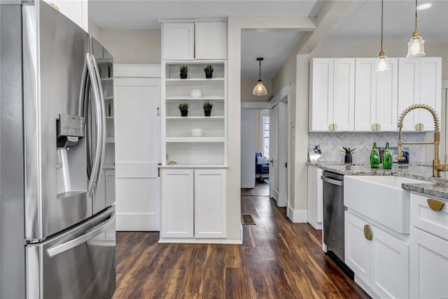 kitchen with a sink, tasteful backsplash, dark wood finished floors, white cabinetry, and appliances with stainless steel finishes