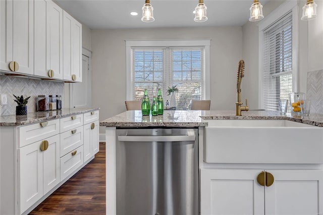 kitchen featuring a wealth of natural light, decorative backsplash, dishwasher, and dark wood-style floors