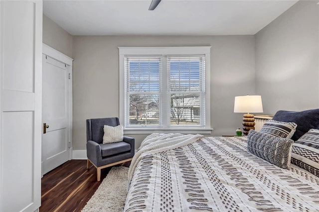 bedroom featuring baseboards, dark wood-type flooring, and a ceiling fan