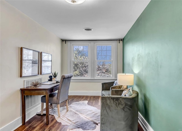 home office featuring visible vents, dark wood-type flooring, and baseboards