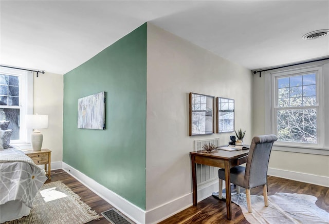 bedroom featuring visible vents, baseboards, and dark wood finished floors