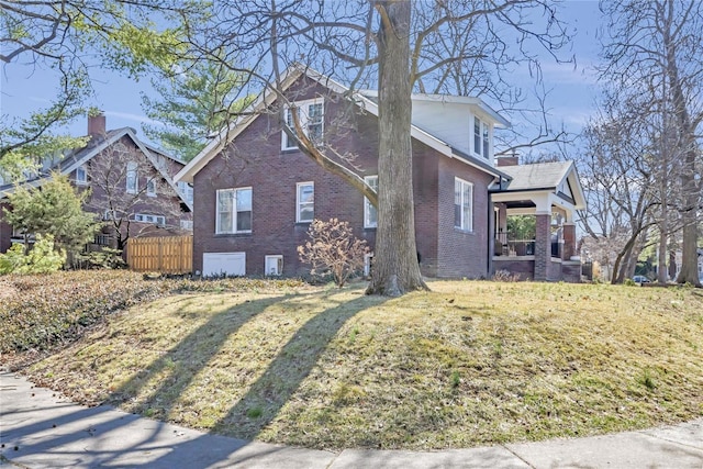 view of side of property with brick siding and fence