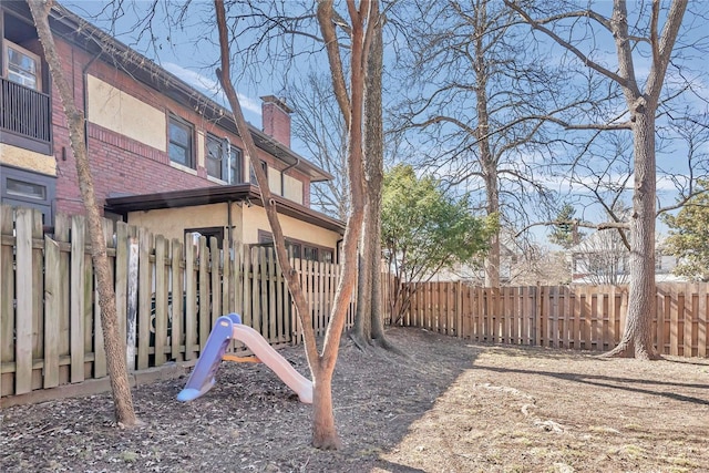 view of yard featuring a playground and fence