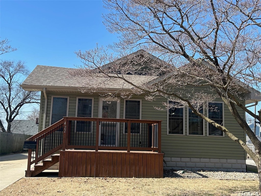 bungalow featuring a porch and roof with shingles