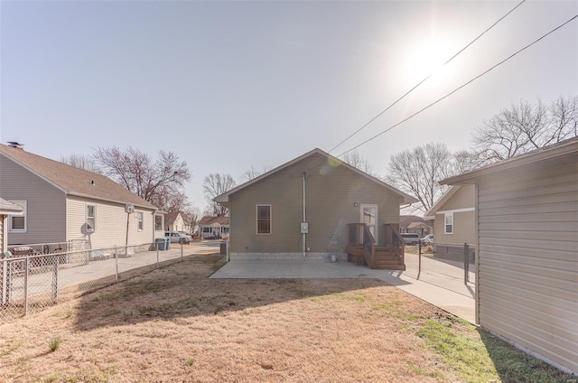 back of house with a yard, a residential view, a patio, and fence