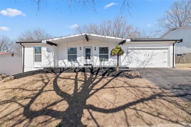 view of front of home featuring brick siding, an attached garage, and concrete driveway