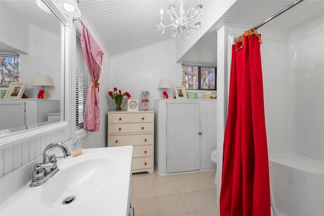 full bath with toilet, a shower with shower curtain, tile patterned floors, a notable chandelier, and vanity