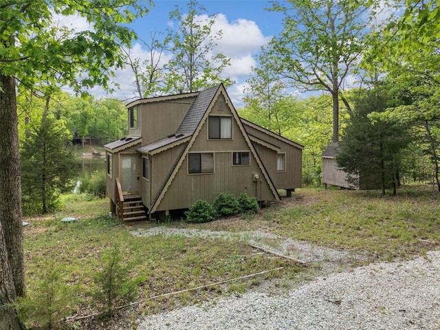 exterior space with roof with shingles