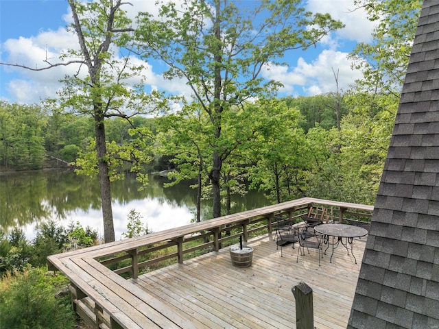 wooden deck featuring a water view and a forest view
