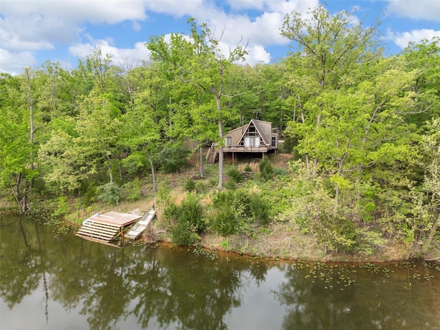 dock area with a forest view and a deck with water view