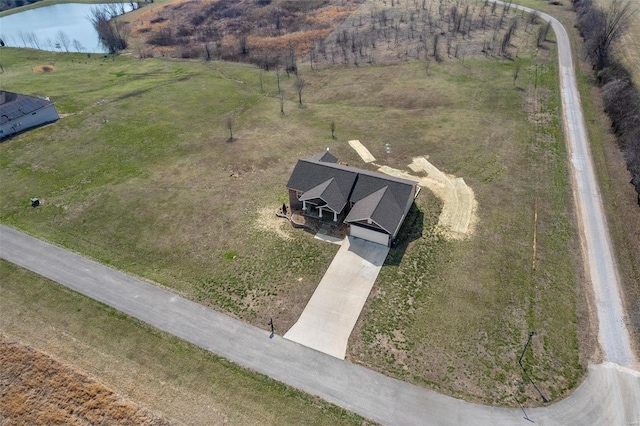 birds eye view of property with a water view and a rural view