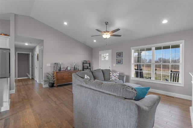 living room with baseboards, ceiling fan, vaulted ceiling, recessed lighting, and hardwood / wood-style flooring