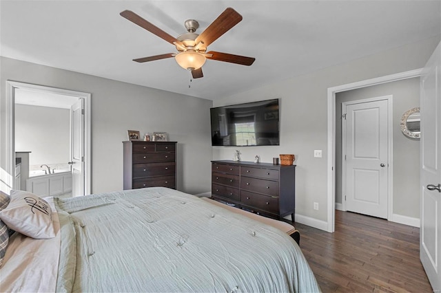 bedroom featuring ceiling fan, ensuite bath, baseboards, and wood finished floors