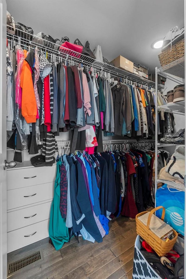 spacious closet featuring visible vents and wood finished floors