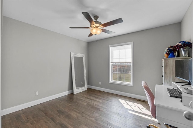 unfurnished office featuring wood finished floors, a ceiling fan, baseboards, and visible vents