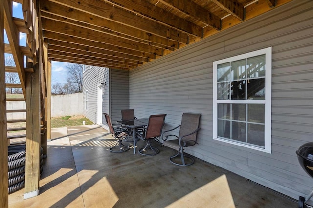 view of patio / terrace featuring outdoor dining area and fence