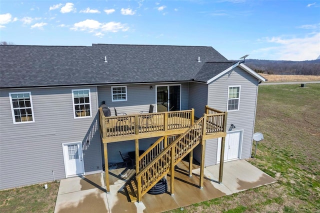 back of house featuring stairway, a patio, a deck, and roof with shingles