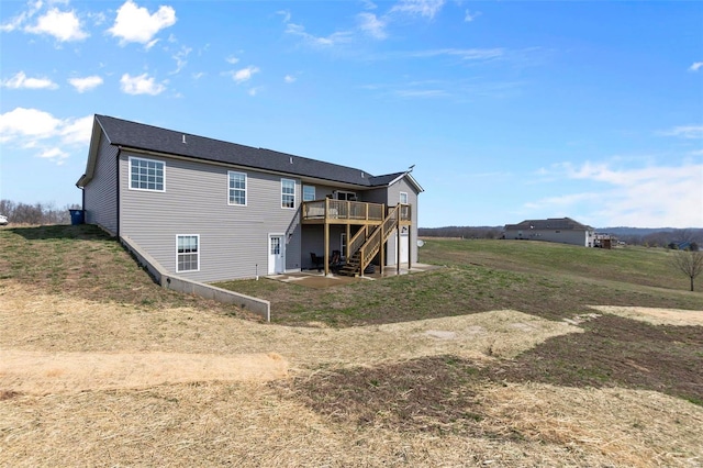 rear view of house with a deck and stairway