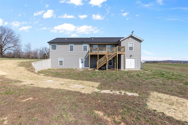 back of property with a wooden deck and stairs