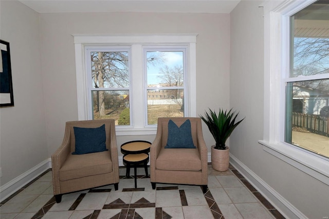 living area featuring baseboards