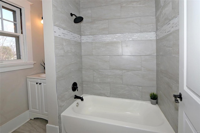 full bath with vanity, baseboards, and shower / bathtub combination