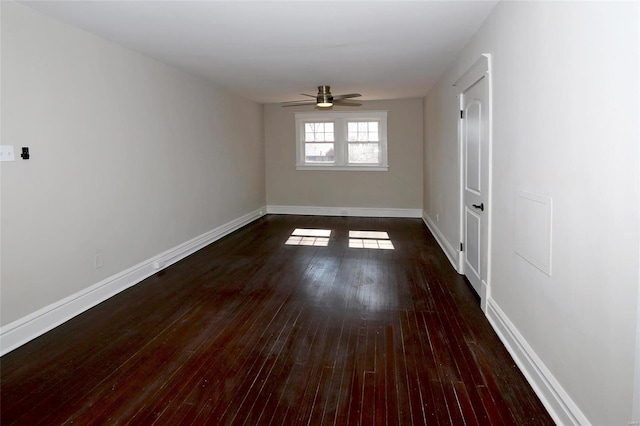 unfurnished room featuring ceiling fan, baseboards, and dark wood finished floors