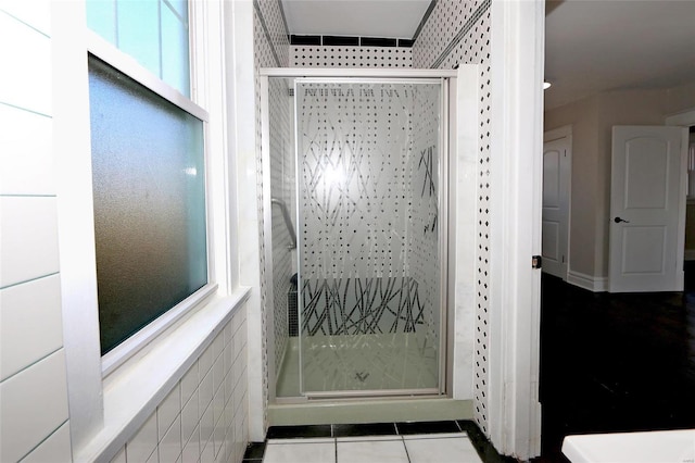 full bath with tile patterned floors and a stall shower