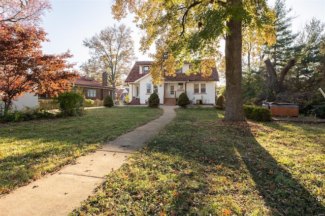 view of front facade with a front lawn and a hot tub